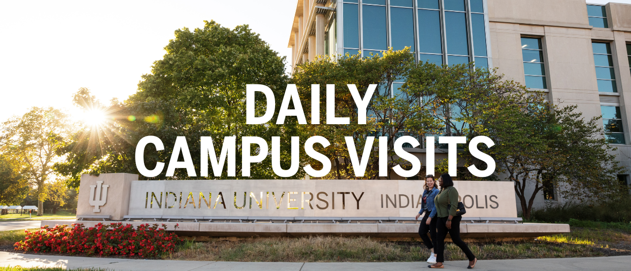 Two students walking in front of IU Indianapolis sign on campus
