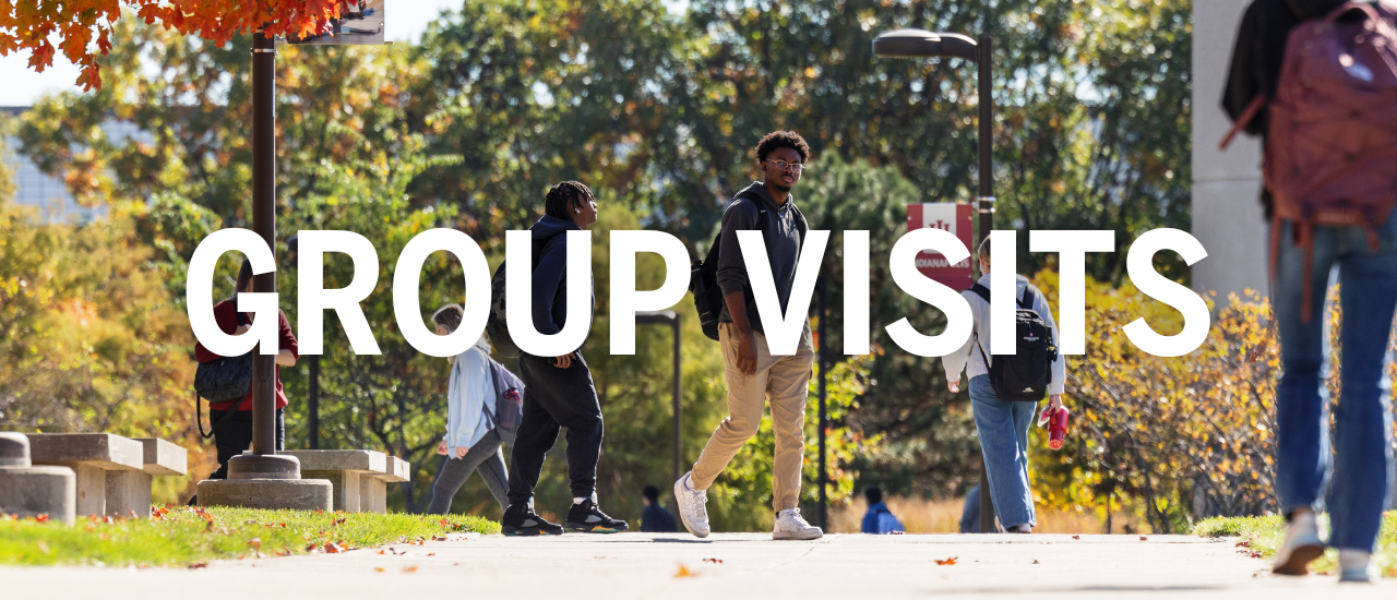 Group Visit text written over a photo of several students walking outside of University Library