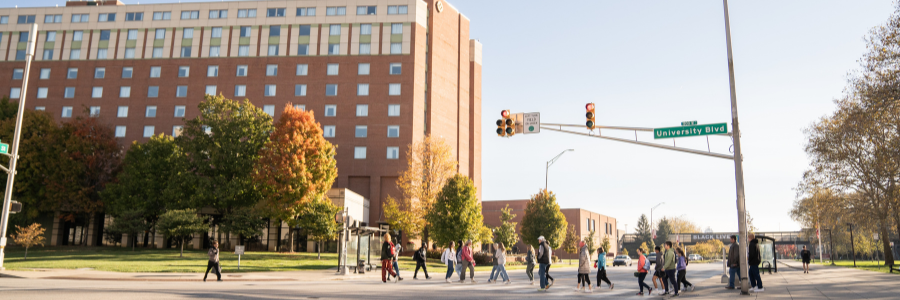 Family walking on the IU Indianapolis campus with a tour guide.
