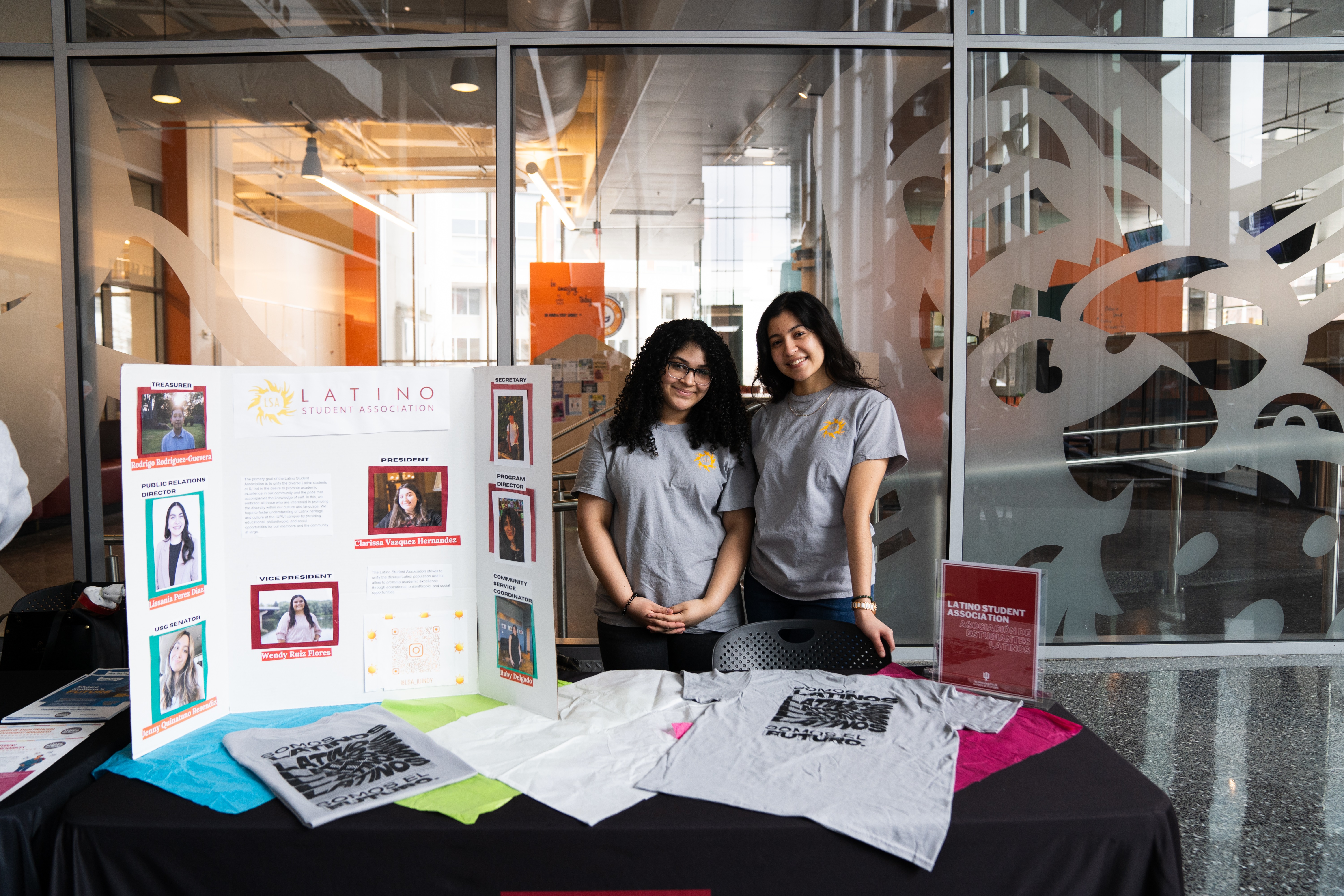 Two female students at a table at the resouce fair in the Campus Center during Somos El Futuro event.